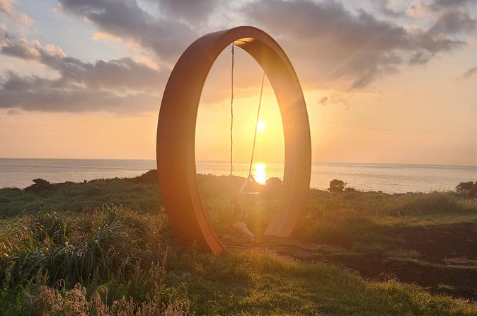 Jeju island Sunrise Tour Early Morning with Hotel Pickup - Photo and wish moments at Seopjikoji: swing, waves, and rock shapes